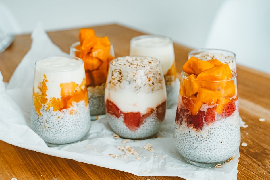Jars of layered overnight oats with fruit on top
